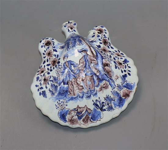 A 19th century Delft flask of shell form, decorated with figures and hunting scene